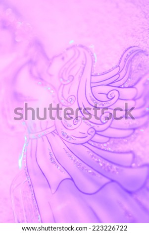 Christmas angel with trumpet soft background in light violet