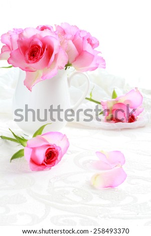 Beautiful romantic pink roses in a white vase still life