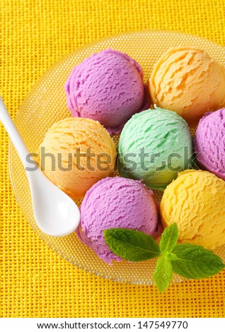 Group of ice cream scoops on a yellow cloth