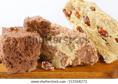 Pieces of chocolate and nuts halva on a cutting board