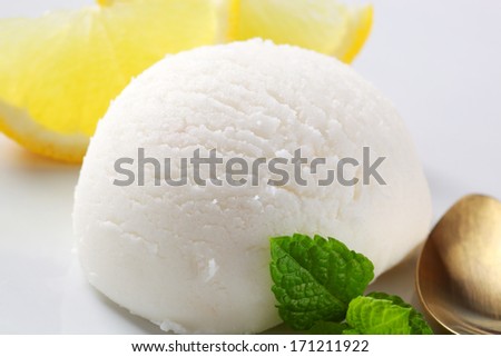Scoop of lemon ice cream with fresh berries