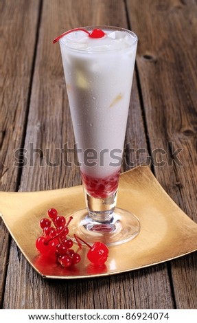 Coconut milk cocktail with red currant and maraschino cherries