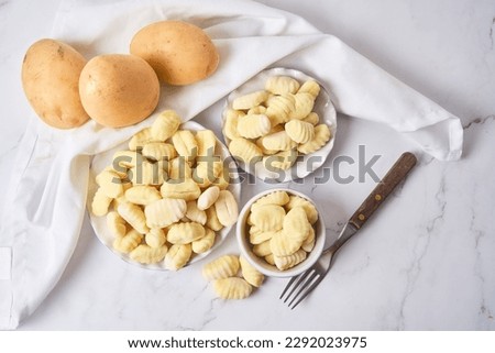 Similar – Image, Stock Photo Homemade gnocchi preparation on rustic kitchen table with ingredients. Top view. Potatoes dough . Italian food concept.