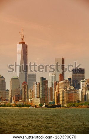View of the Manhattan skyline at sunset, taken from the Staten Island ferry, as it crosses the Hudson River, New York