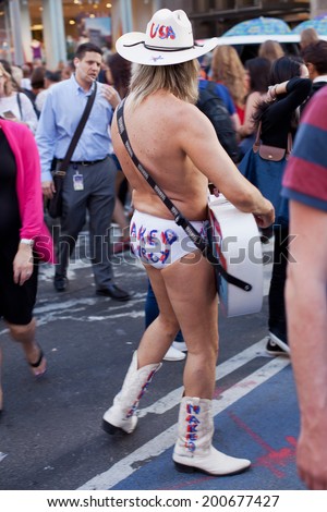 NY - JUNE 5 2013-Robert John Burck known as the Naked Cowboy performing his daily routine in New York City\'s Times Square  June 5th 2013.