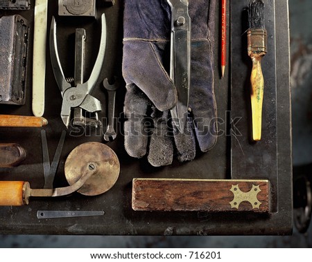 Still life of various tools of trade for the craft of hand bookbinding and embossing