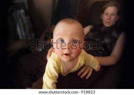 Baby Boy on his Motherâ€™s lap, leaning towards camera (some noise).