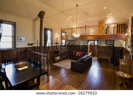 Interior views of a timber house, with polished timber floors