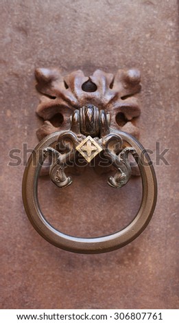 Ornate metal door knocker on metal door, Barcelona, Spain