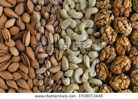 Assorted nuts almonds, pistachio, cashews, walnut. Flatly organic mixed nuts background. Healthy food, useful microelements and vitamins. Useful health snack.Vegetarian snack of different nuts