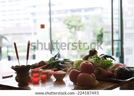 Food and candles on table as religious offering