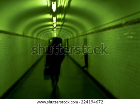 Person walking in subway tunnel, Paris, France