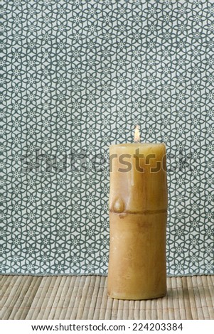 Single pillar candle, burning