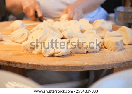 Similar – Image, Stock Photo Cooking doughnuts process. Homemade dough and deep-fried donuts, top view