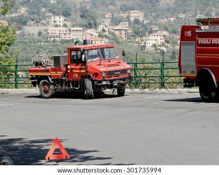 GENOA, ITALY - SEPTEMBER 7, 2009: Vehicle Iveco firefighter's blocking the road near a large forest fire.