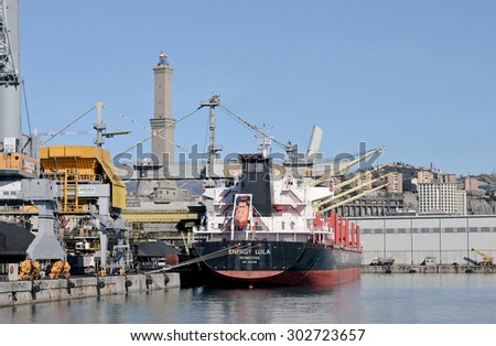 GENOA, ITALY - FEBRUARY 21, 2013: The bulk carriere registered in Liberia ENERGY LULA. Cargo ship designed for the transportation of coal. In the background the lighthouse, symbol of the port Genoa.
