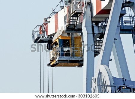 GENOA, ITALY - JULY 21, 2015: The cockpit and pilot of a crane on the docks of the commercial port of Genoa.