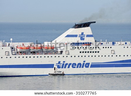 GENOA, ITALY - AUGUST 26, 2015: The ferry Athara of the shipping company TIRRENIA leaves the port of Genoa.