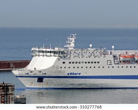 GENOA, ITALY - AUGUST 26, 2015: The ferry Athara of the shipping company TIRRENIA leaves the port of Genoa.