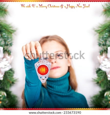 Young girl with a Christmas light. We wish U a Merry Christmas and a Happy New Year!
