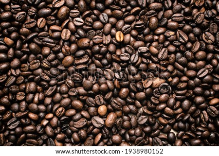 Coffee beans. Coffee beans are spread out on the surface.