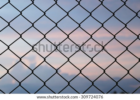 metallic fence at the sunset