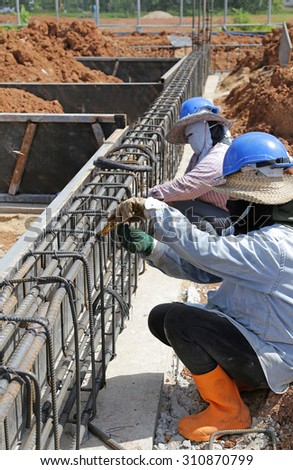 lady worker do reinforcing steel bars for building, construction site