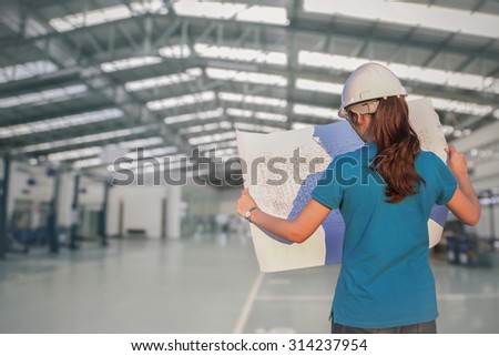 female construction engineering  reviewing blueprints at construction site