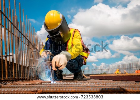 A contractor welding metals