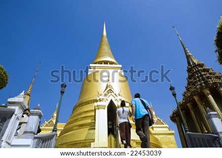 Young man and woman travel in Grand Palace Bangkok