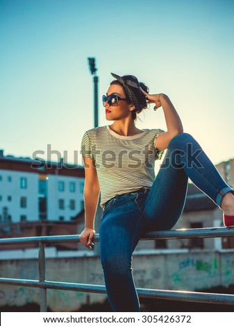 Outdoor fashion look of young woman wearing summer sunglasses. Wear summer bright outfit,vintage summer outfit colors.Hipster teenager girl