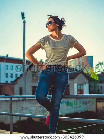 Outdoor fashion look of young woman wearing summer sunglasses. Wear summer bright outfit,vintage summer outfit colors.Hipster teenager girl