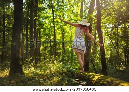 Similar – Image, Stock Photo Woman walking and balancing on a wooden railing at the coast line.