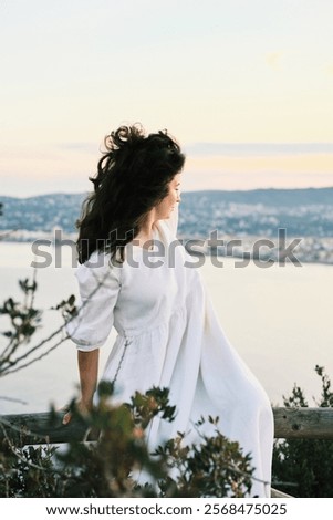 Similar – Image, Stock Photo Coastal landscape and girl in yellow hooded coat looking at sea and walking. Copy space.