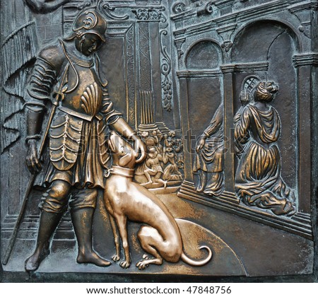 Close up shot of bronze board on Charles Bridge in Prague. The legend says when you touch the dog your partner will always be faithfully.