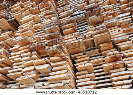 Pile lumber near a lumber mill, waiting for shipping.