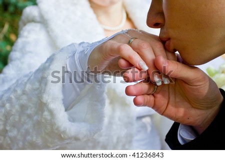 The groom kisses a hand to the bride