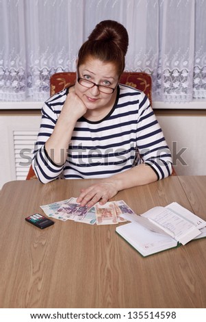Elderly woman holding money in hand