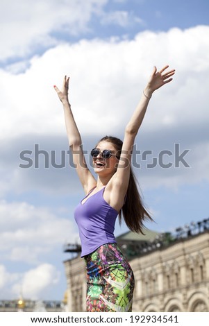 Portrait of young woman enjoying life against the blue sky