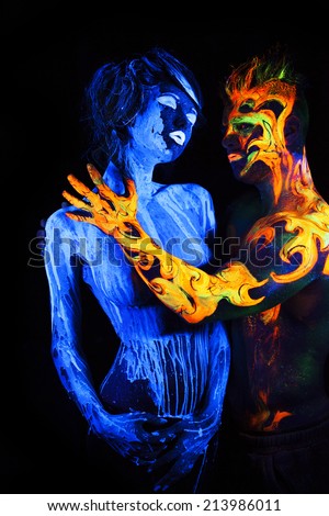 Body art glowing in ultraviolet light,  four elements, Water against Fire