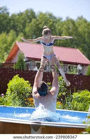 Happy family, active father with little child, adorable toddler girl swim in the pool