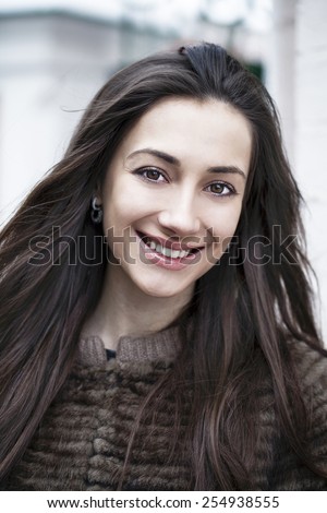 Young beautiful woman on a background of a winter street
