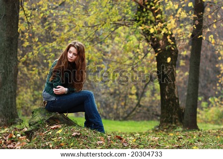 Beautiful young woman in autumnal park