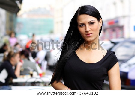 Closeup portrait of a happy young woman smiling  on urban background