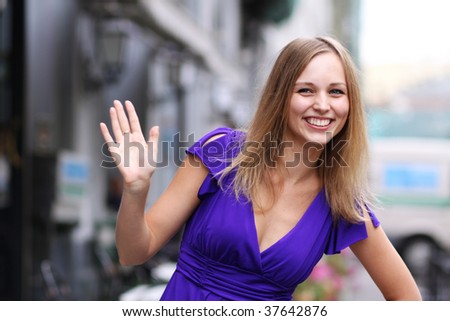 portrait of a happy young woman smiling on urban background