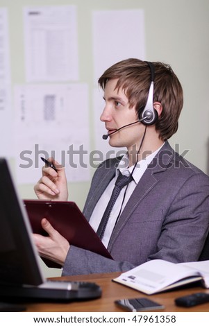A friendly telephone operator in an office environment.