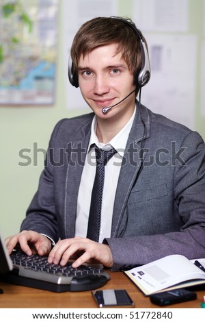 A friendly telephone operator in an office environment.