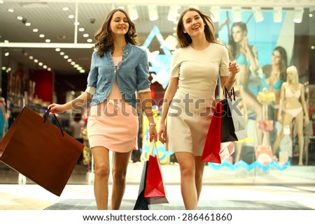 MOSCOW, RUSSIA - CIRCA MAY 2015: Two young girls walk around the store with shopping bags in their hands at Shopping center 