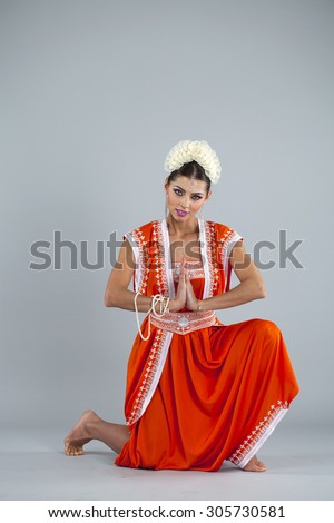 Full body cheerful traditional Asian Indian woman in indian sari, isolated on gray background