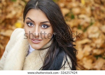 Facial portrait of a beautiful arab woman warmly clothed autumn outdoor